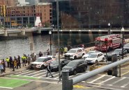 First responders and onlookers gather along Fort Point Channel