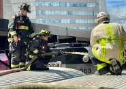 Firefighters on top of a commuter-rail train at North Station