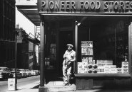 Man leaning against window of Pioneer Food on Beacon Hill